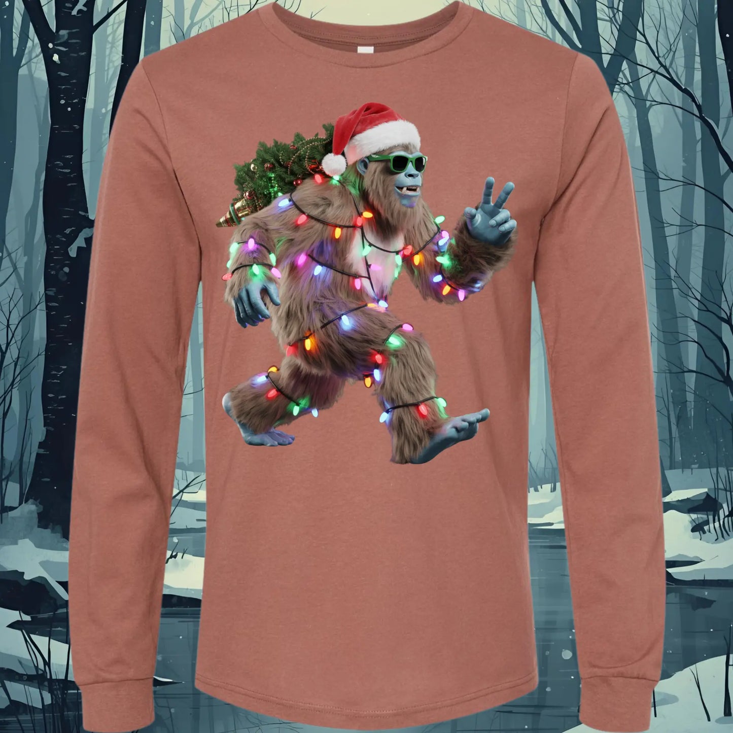 Long-sleeve shirt with a Christmas-themed Bigfoot Santa design in a snowy forest background