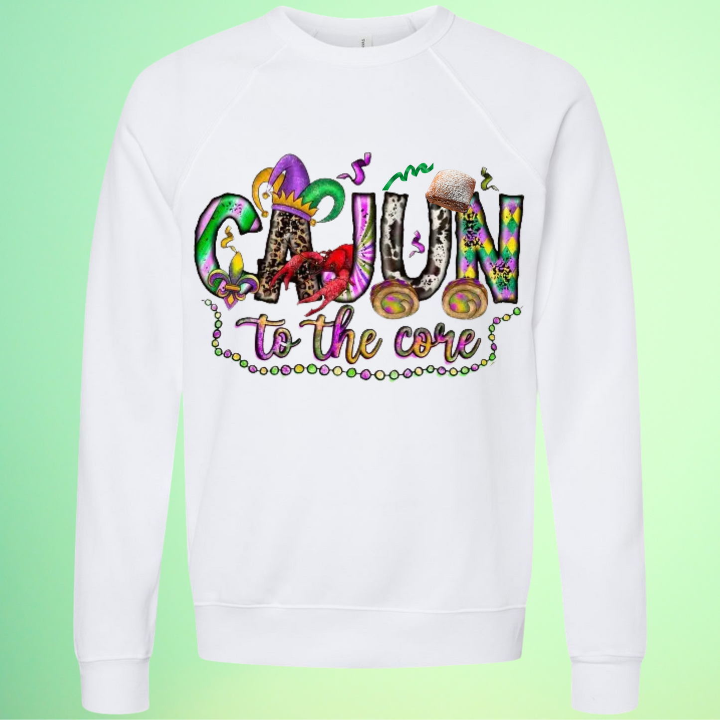 White sweatshirt with colorful 'Cajun to the core' text on a green background