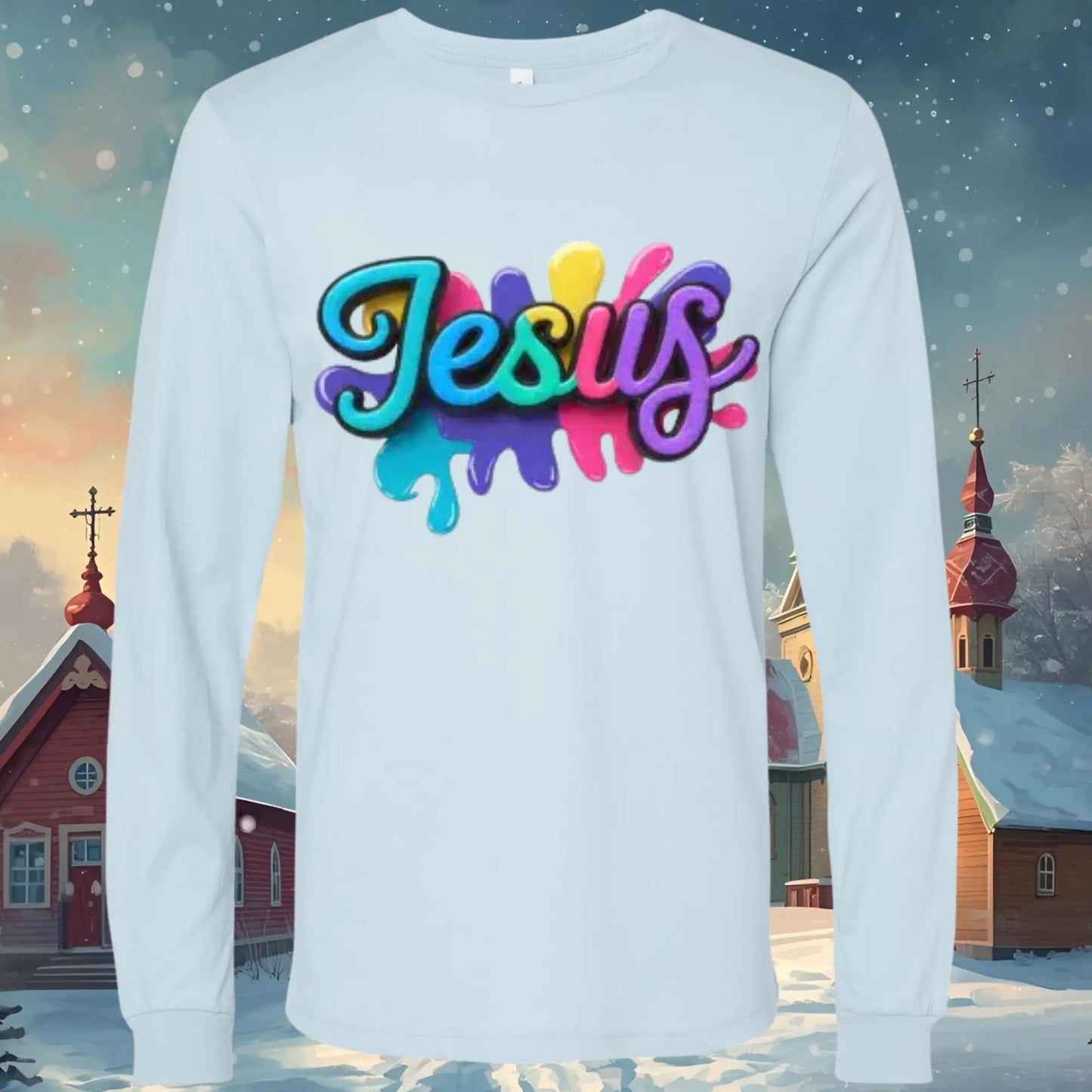 White long-sleeve shirt with colorful name 'Jesus' design against a snowy village background