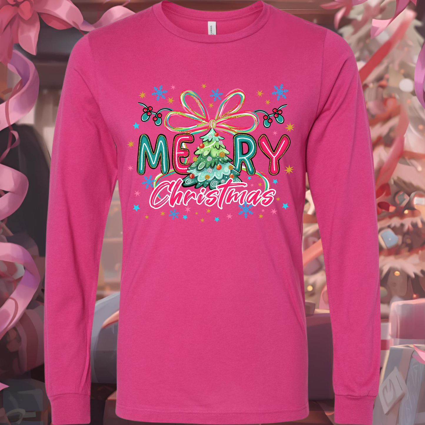 Pink long-sleeve shirt with 'Merry Christmas' design featuring a Christmas tree and colorful elements.