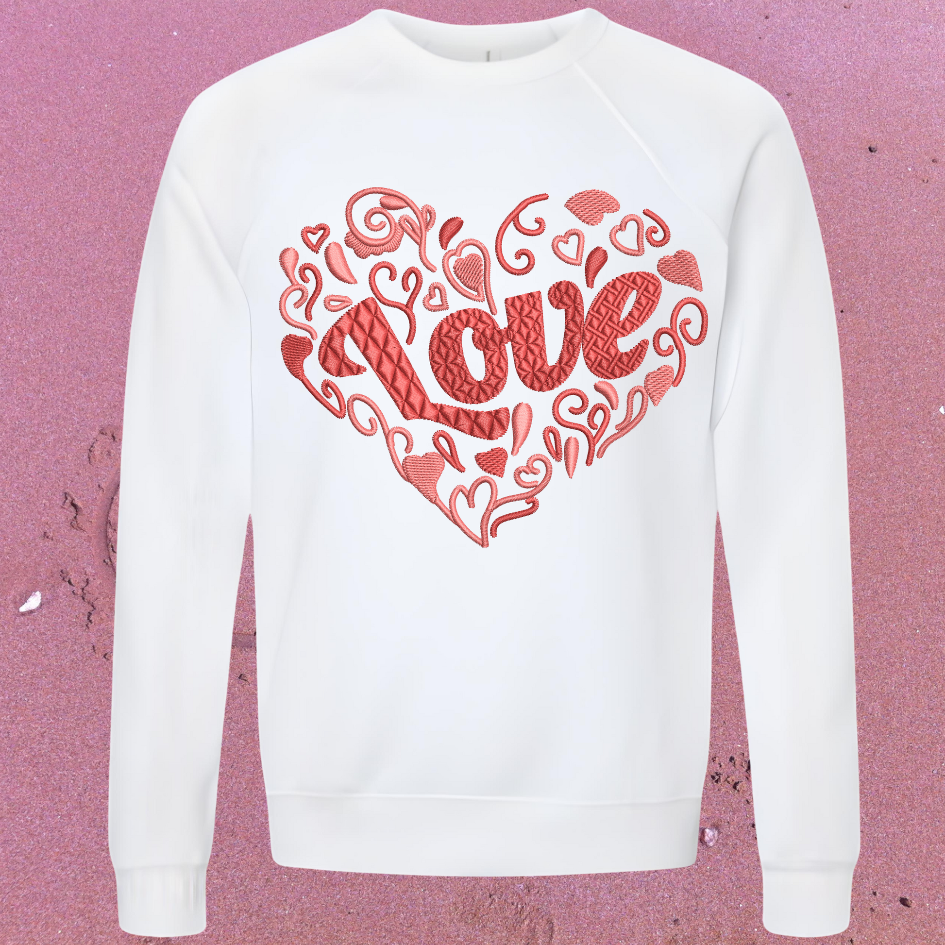 White sweatshirt with red 'LOVE' design on a pink textured background perfect for Valentines
